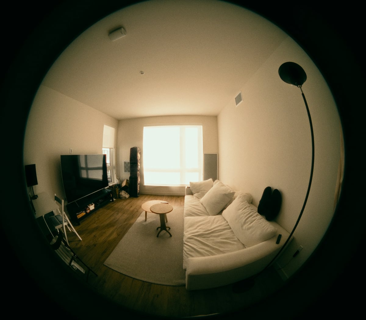 An IP camera mounted in a living room monitors a bright home interior